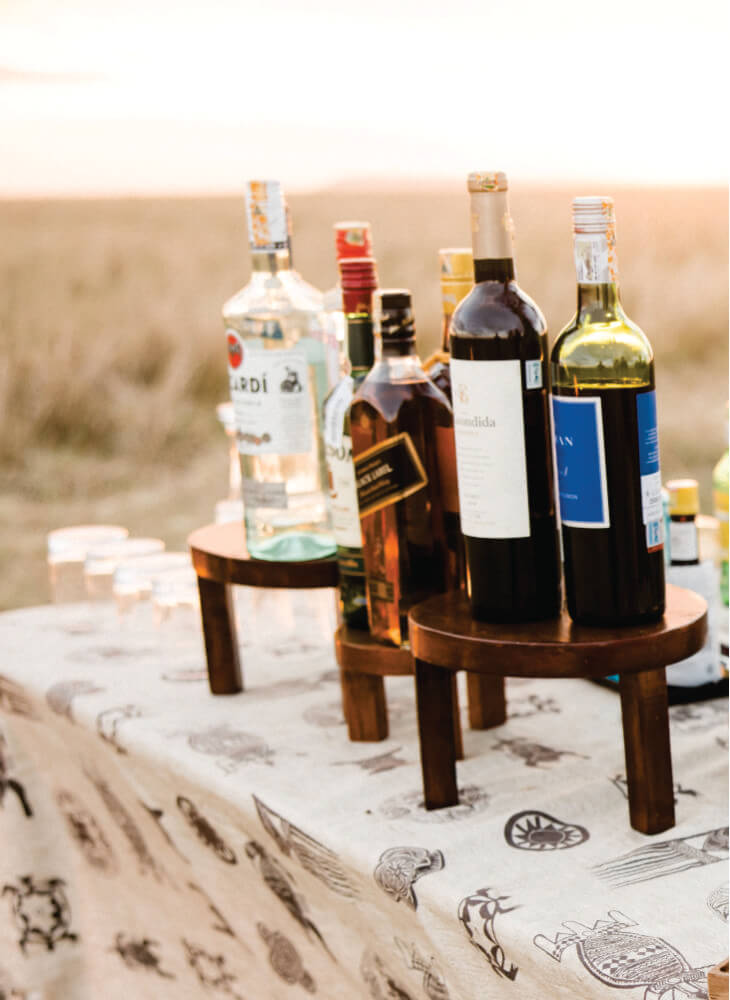 Elegant table-setting wine bottles at Lion Sands Masai Mara Lodge creating a beautiful centerpiece on budget luxury stay at Masai Mara tented camp