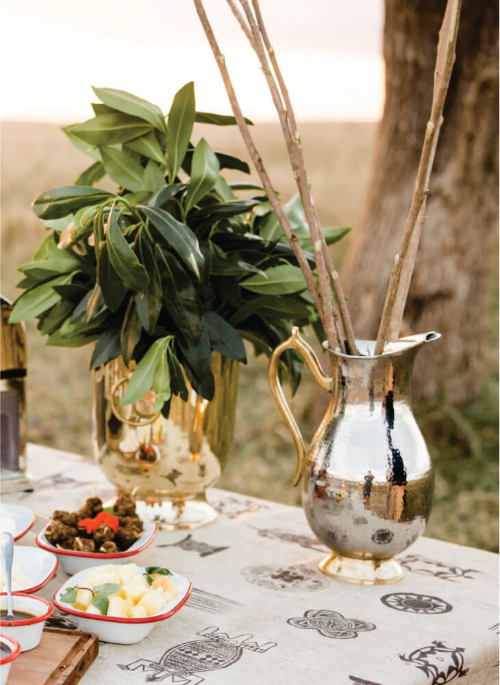 Lunch table setting with delicious meals in the field at Lion Sands Masai Mara Lodge on budget accommodation in Masai Mara