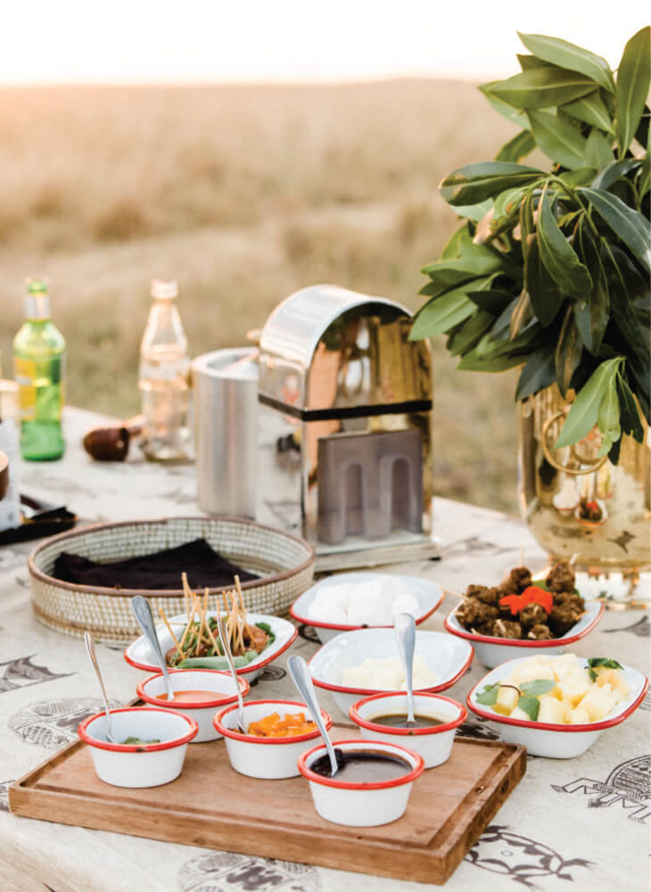 Elegant table-setting with food at Lion Sands Masai Mara Lodge, creating a beautiful centerpiece on budget luxury stay at Masai Mara tented camp